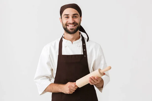 Image of young chief man in cook uniform smiling and holding kit — Stock Photo, Image