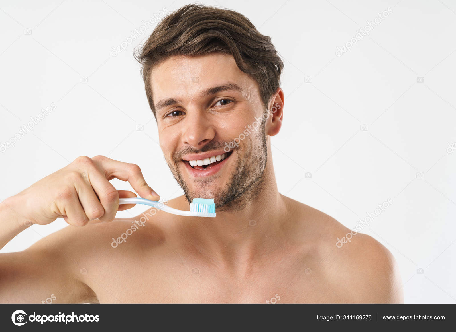 Cheery positive young naked man brushing his teeth isolated over white  background. Stock Photo by ©Vadymvdrobot 311169276