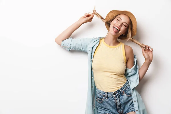 하얀 벽을 배경으로 고립된 모자를 쓰고 있는 낙천적 이고 아름다운 젊은 여성, 행복 한 미소짓고 있다. — 스톡 사진