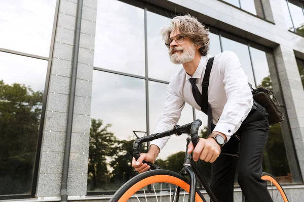 Yakışıklı, kendine güvenen, sakallı, takım elbiseli adam.