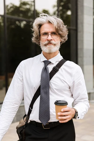 Attractive mature businessman wearing suit walking — Stock Photo, Image