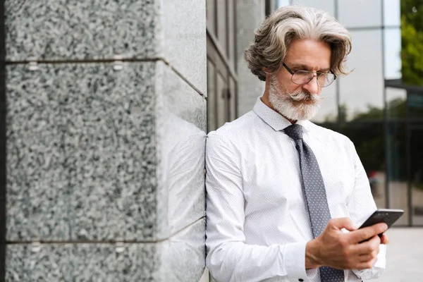 Attractive mature businessman wearing suit walking — 스톡 사진