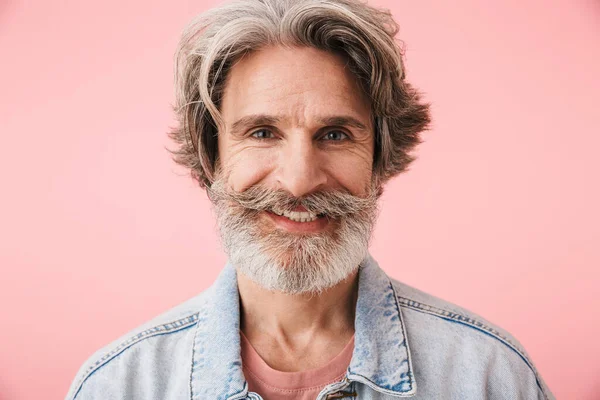 Portrait closeup of pleased old man 70s with gray beard smiling and looking at camera
