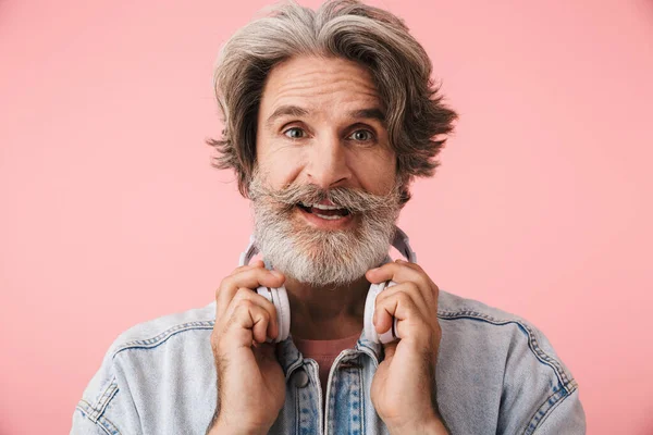 Portret van tevreden oude man met grijze baard in denim jack — Stockfoto