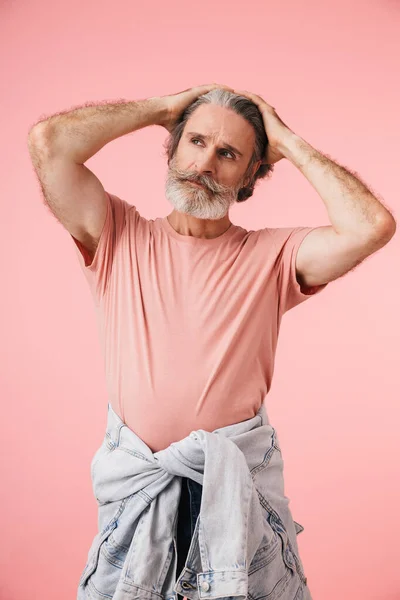 Portrait of masculine thoughtful mature man 70s with gray beard looking aside at copyspace — Stock Photo, Image