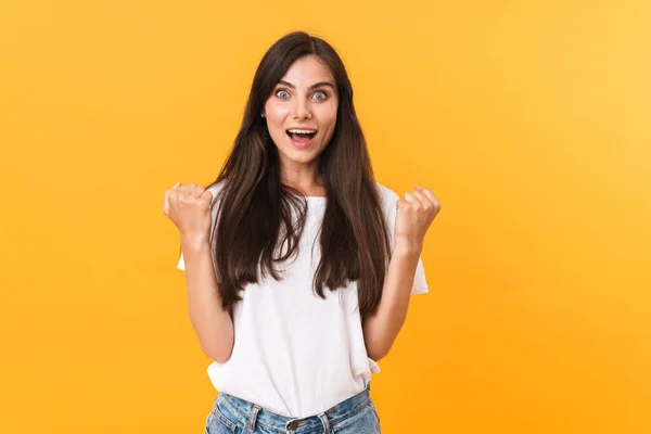 Image of young brunette woman with long hair smiling and clenchi — 스톡 사진