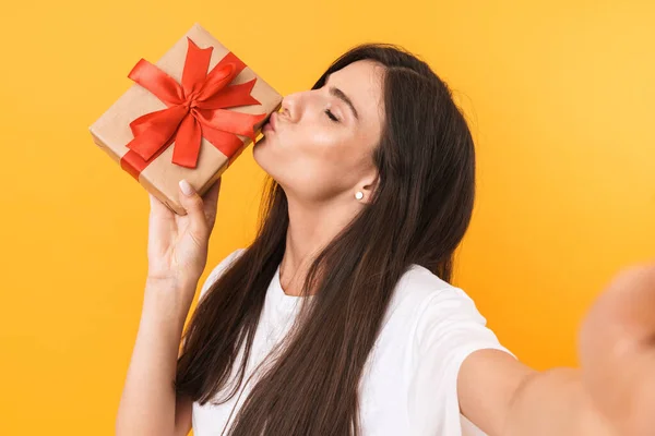 Imagem de mulher morena encantadora com cabelo comprido segurando presente — Fotografia de Stock