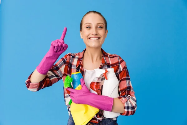 Portrait of cheerful housewife in rubber gloves holding detergen — Stock Photo, Image