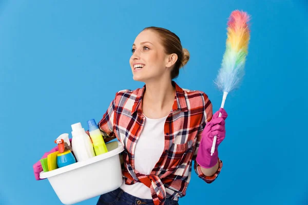 Portrait of beautiful housewife in rubber gloves holding basin w — Stock Photo, Image