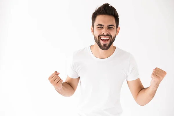 Imagem de jovem encantado agarrando punhos e sorrindo — Fotografia de Stock