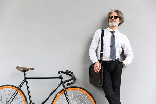 Zdjęcie eleganckiego starego biznesmena stojącego na rowerze — Zdjęcie stockowe