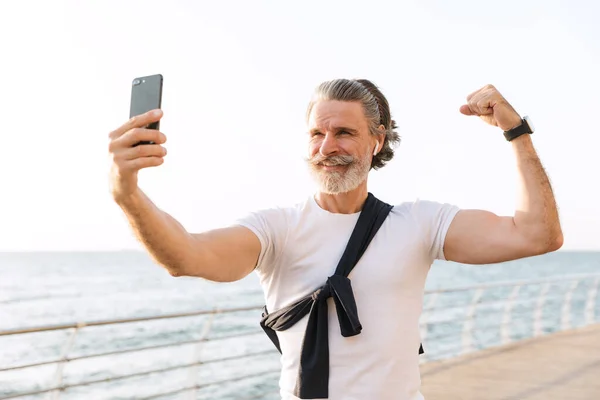 Immagine di un vecchio sorridente che scatta foto di selfie sul cellulare — Foto Stock