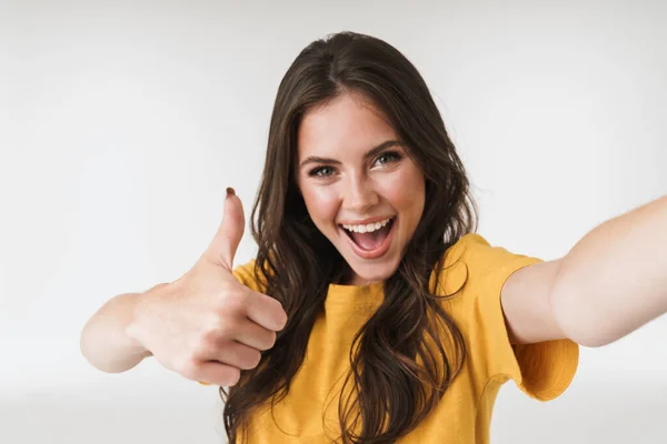Kép izgatott barna nő mosolyog és mutatja hüvelykujját fel whi — Stock Fotó