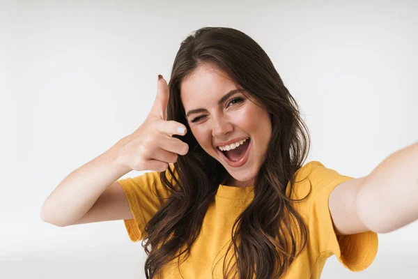 Image of beautiful brunette woman smiling and pointing finger at — Stock Photo, Image