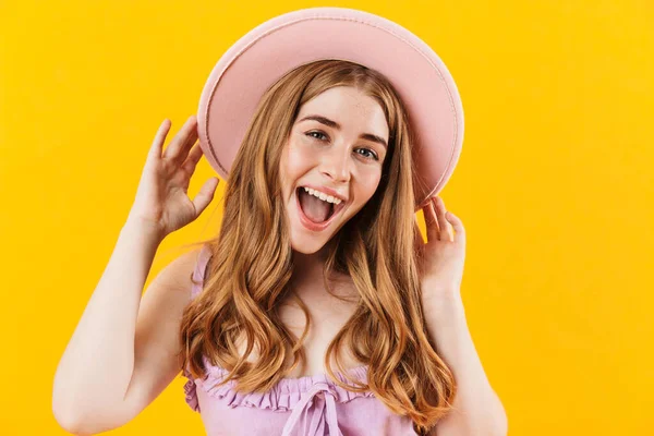 Gadis ceria yang bahagia terisolasi di atas dinding kuning latar belakang mengenakan topi . — Stok Foto