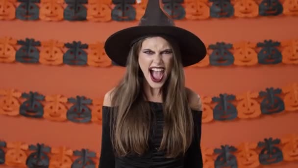 Pretty Aggressive Young Witch Woman Black Halloween Costume Screaming Loudly — Stock Video