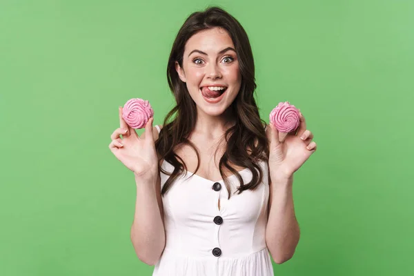 Image Excited Young Woman Smiling Holding Marshmallows Isolated Green Background — Stock Photo, Image