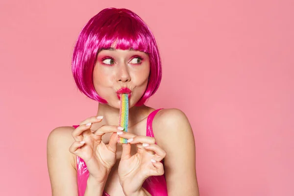 Image Joyful Beautiful Woman Wig Making Fun Marmalade Isolated Pink — Stock Photo, Image