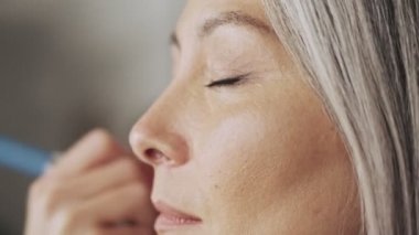 Güzellik salonunda makyaj sanatçısı olan muhteşem yaşlı bir kadın müşterinin yakın çekimi.