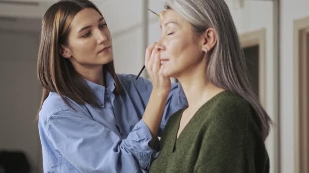 Serio Artista Maquillaje Joven Está Haciendo Maquillaje Para Una Mujer — Vídeos de Stock