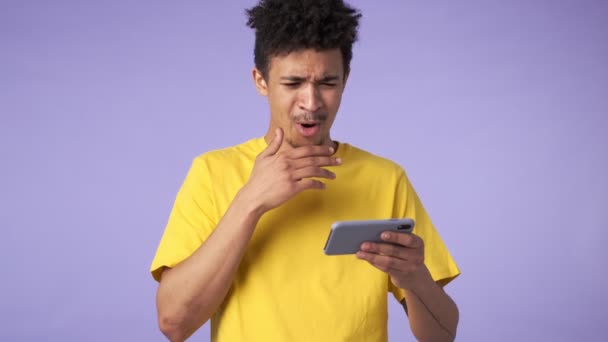 Joven Africano Sorprendido Disgustado Chico Aislado Sobre Púrpura Fondo Ver — Vídeo de stock