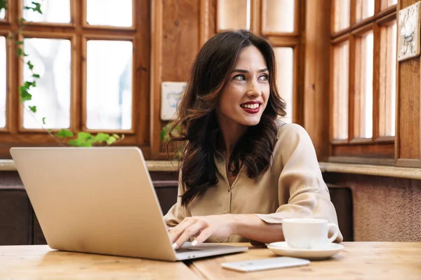 Imagem Mulher Adulta Morena Feliz Sorrindo Trabalhando Com Laptop Enquanto — Fotografia de Stock