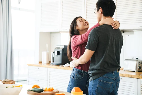 아름답고 아시아인 부엌에서 포옹하는 — 스톡 사진