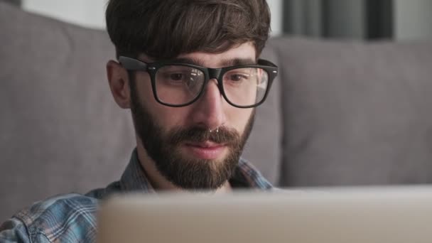 Focused Young Hipster Man Wearing Glasses Casual Clothes Using His — Stock Video