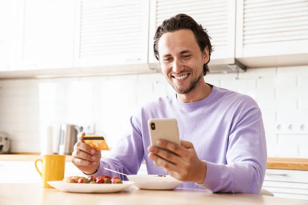 Attractive Happy Young Man Sitting Kitchen Table Having Breakfast Eating — Stock Photo, Image