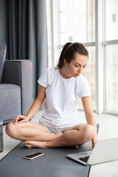 Image Concentrated Woman Typing Notebook Cellphone While Sitting Mat Window — Stock Photo, Image