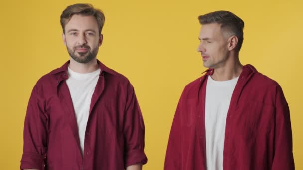 Two Adult Men Wearing Red Shirts Arguing Standing Isolated Yellow — Stock Video