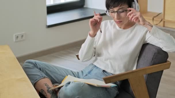 Una Joven Encantadora Está Quitando Las Gafas Mientras Escucha Música — Vídeo de stock