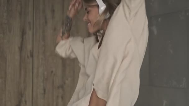 Neşeli Çekici Kulaklıklı Evde Müzik Dinleyen Dans Eden Sarışın Kadın — Stok video
