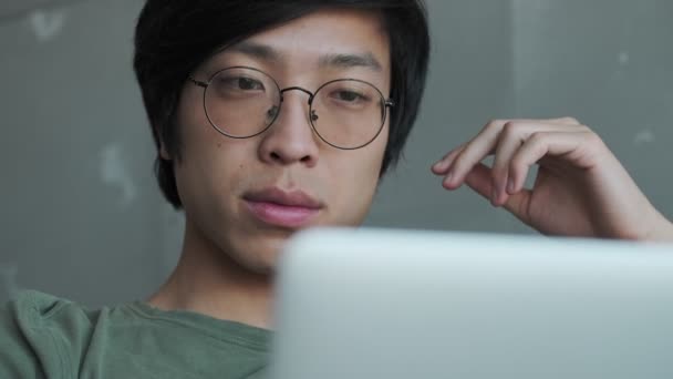 Nahaufnahme Eines Ruhigen Jungen Asiatischen Mannes Mit Brille Der Mit — Stockvideo