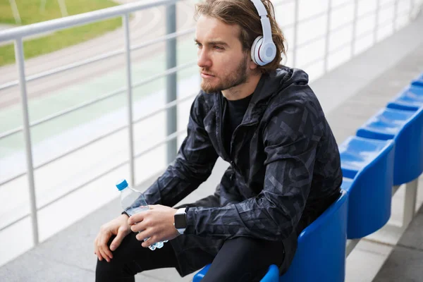 Jovem Desportista Confiante Sentado Assentos Tribunos Estádio Ouvindo Música Com — Fotografia de Stock