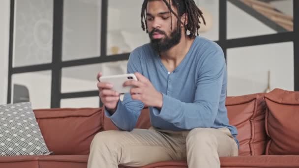 Serious Concentrated Young African American Man Playing Games Smartphone Living — Stock Video