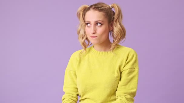 Blue Eyed Blonde Girl Yellow Sweater Guilty Face Bites Her — Stock Video