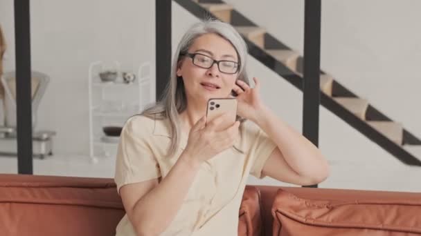 Een Geconcentreerde Volwassen Vrouw Met Een Bril Met Lang Grijs — Stockvideo