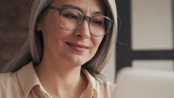 Gözlüklü Gülümseyen Olgun Bir Kadının Yakından Görüntüsü Evinde Oturan Gümüş — Stok video