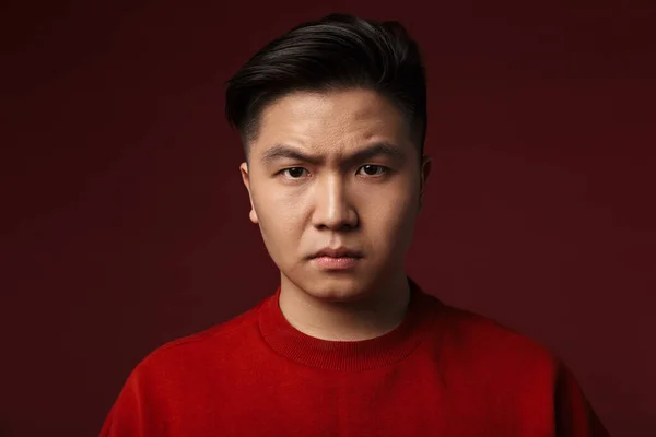 Image Displeased Young Asian Man Posing Looking Camera Isolated Burgundy — Stock Photo, Image