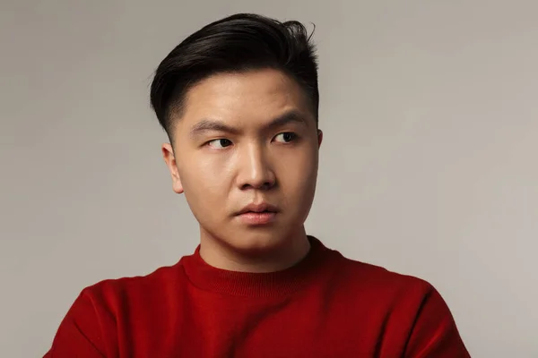 Image Displeased Young Asian Man Posing Looking Aside Isolated Gray — Stock Photo, Image