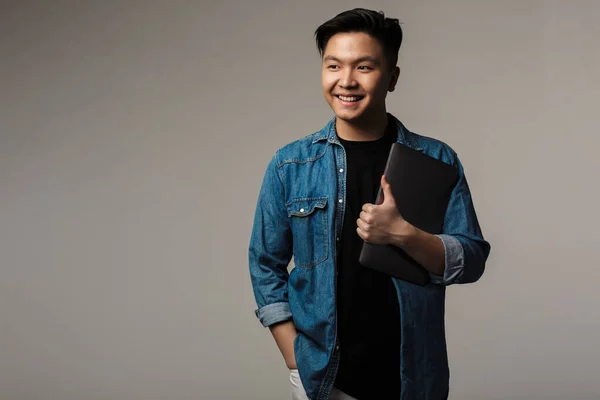 Image Cheerful Handsome Asian Man Smiling Holding Laptop Isolated Gray — Stock Photo, Image