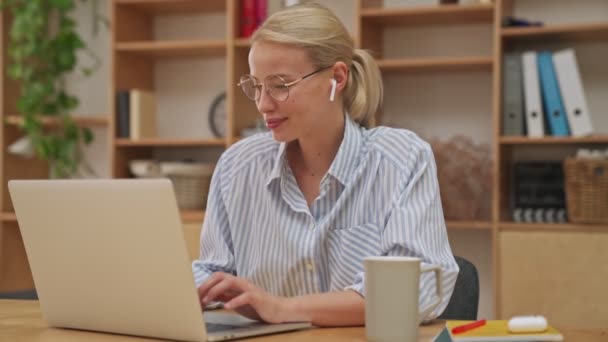 Happy Cheerful Young Blonde Businesswoman Earbuds Typing Something Her Laptop — Stock Video