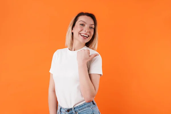 Image Beautiful Cheerful Woman Smiling Pointing Finger Aside Isolated Orange — Stock Photo, Image