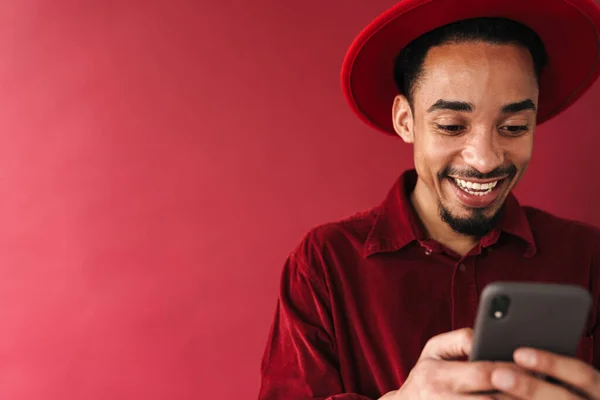 Handsome Smiling Stylish Young African Man Using Mobile Phone While — Stock Photo, Image