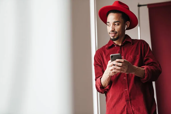 Image Handsome Young Man Posing Indoors Window Using Mobile Phone — Stock Photo, Image