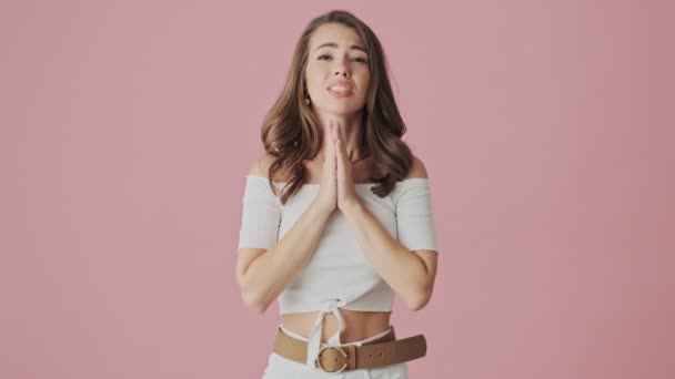 Emotional Young Woman Praying Something Standing Isolated Pink Background Studio — Stock Video