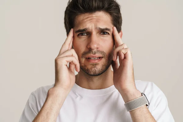 Portrait Unhappy Young Man Headache Rubbing His Temples Isolated White — Stock Photo, Image