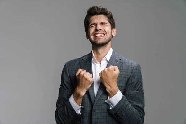 Photo Excited Handsome Businessman Making Winner Gesture Camera Isolated Grey — Stock Photo, Image