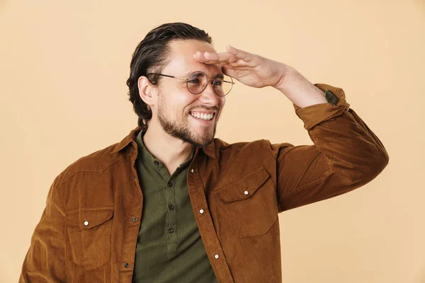 Image Young Happy Man Eyeglasses Smiling Looking Aside Isolated Beige — Stock Photo, Image